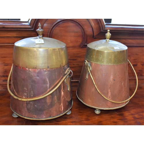 61 - A near pair of Middle Eastern copper and brass vessels, swing handles, raised on three feet, the lar... 