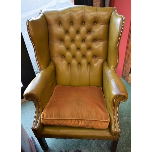 63 - A Chesterfield type wingback reception chair, deep button back, scroll arm, 112cm high