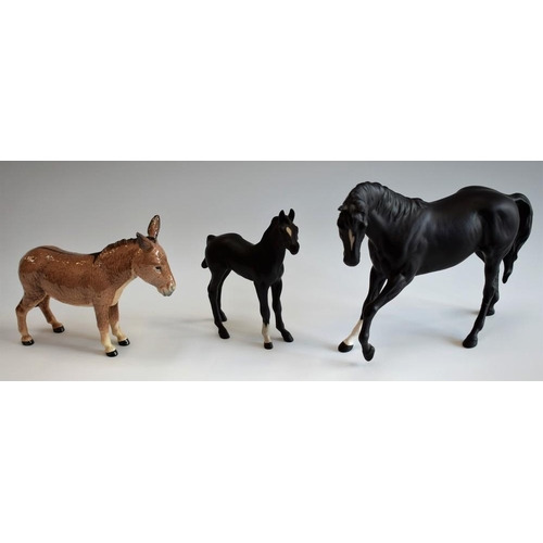 77 - A Beswick black horse and foal, matte finish; a Beswick donkey (3)