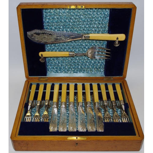 285 - A Victorian EPNS fish set for 12, etched blades swimming fish, light oak case