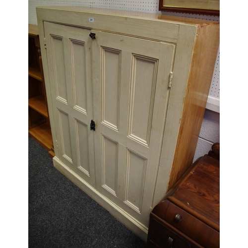 428 - A painted pine estate cupboard tow panel doors enclosing shelving plinth base.