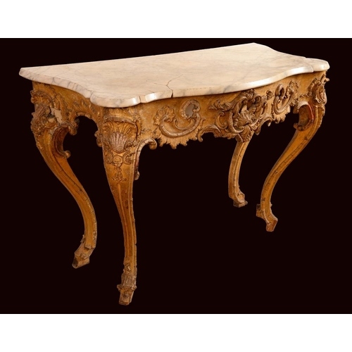 1222 - A Rococo giltwood and gesso console table, shaped serpentine marble top above a deep frieze moulded ... 