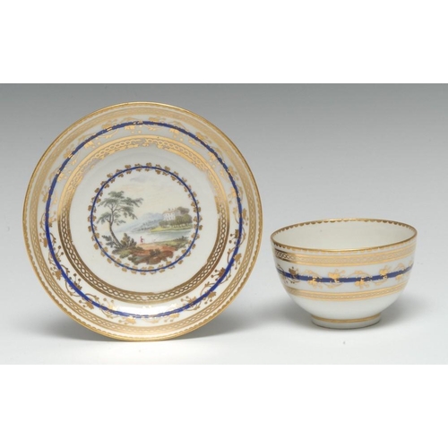 143 - A Derby tea bowl and saucer, painted by Zachariah Boreman with figures in a river landscape, within ... 