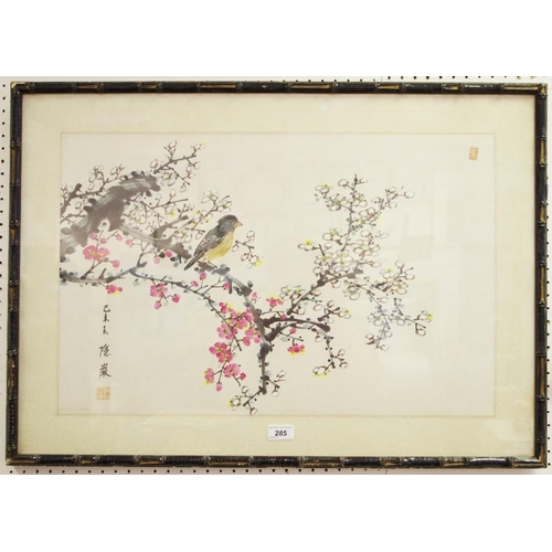 285 - An oriental watercolour - a bird on a flowering branch, signed and framed.