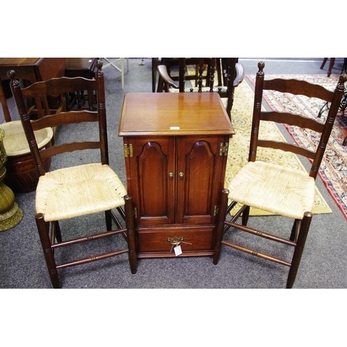 314 - A reproduction oak music cabinet in a late 18th century manner, hinged cover above fielded panelled ... 