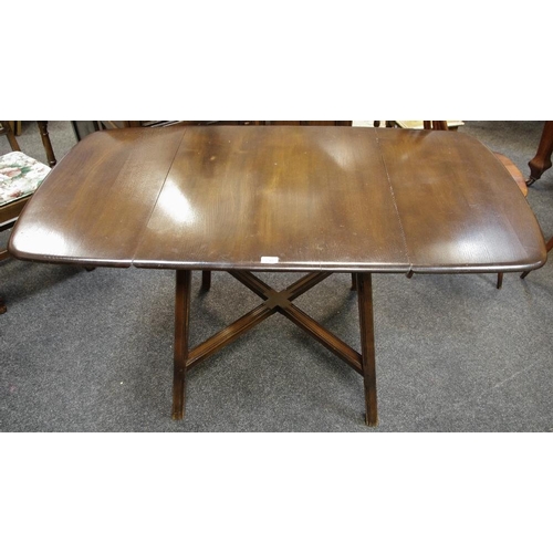 320 - An Ercol dropleaf dining table, and two Ercol Colonial carver chairs.