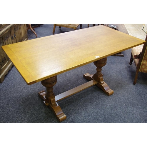 329 - An oak table, plank top, cup and cover supports