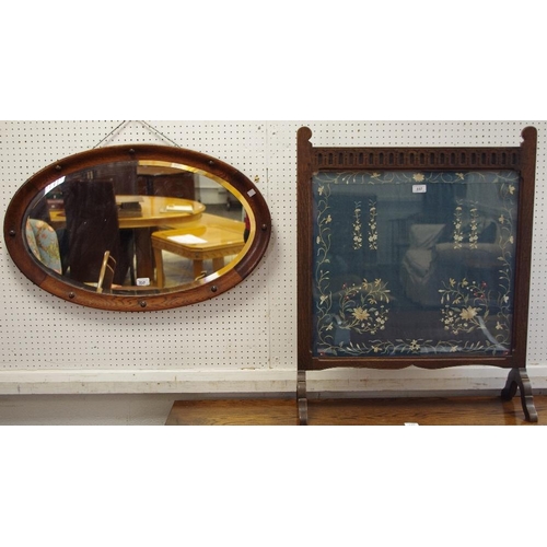 337 - An early 20th century oak mirror, intermittent ball decoration; an early 20th century tapestry fire ... 