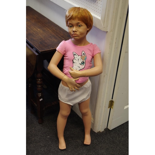 338 - A large shop front mannequin child, red hair, 102cm high