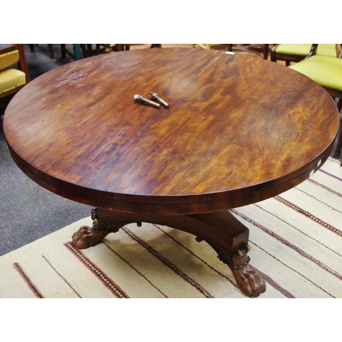 355 - A William IV flame mahogany centre table, circular top, turned column, incurved triform base, lion p... 