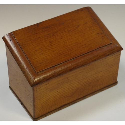 11 - A late Victorian oak slope top stationery box, hinged cover enclosing an arrangement of compartments... 