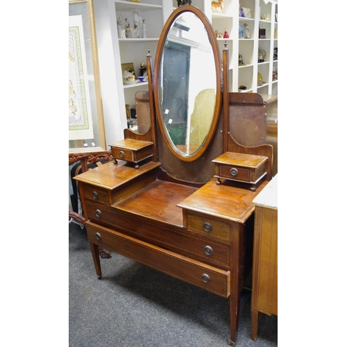 114 - An Edwardian mahogany two piece bedroom suite comprising double wardrobe, stepped cornice over mirro... 