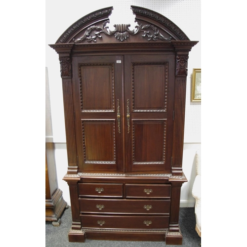 132 - A contemporary Indonesian hardwood armoire style wardrobe, carved arched superior structure, above t... 