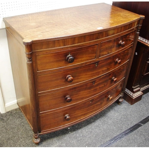 133 - A George III bowfront chest of two short cockbeaded drawers over three long flanked by reeded pilast... 