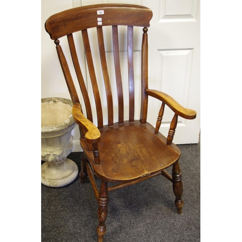 144 - A farmhouse lathe back armchair.