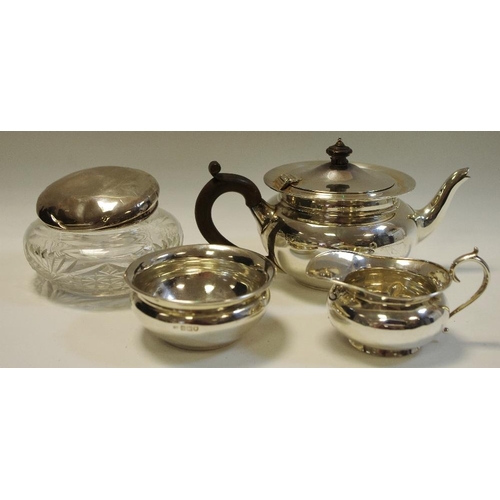 161 - A silver tea service comprising teapot, milk and sugar; a white metal topped glass jar. (4)