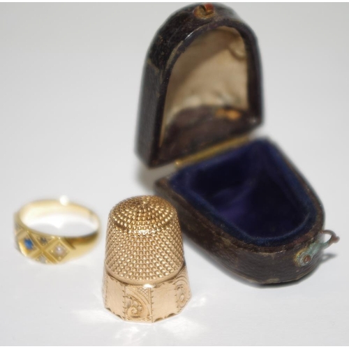 181 - A 19th century gold coloured ring set with sapphire; gold coloured thimble, c.1880