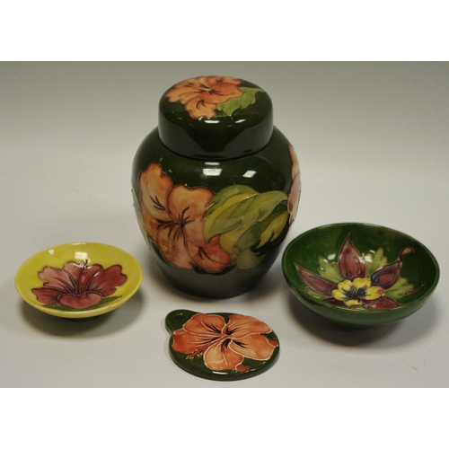 22 - A Moorcroft Hibiscus ginger jar & cover, green ground 16cms high; others,  Hibiscus pattern pedestal... 