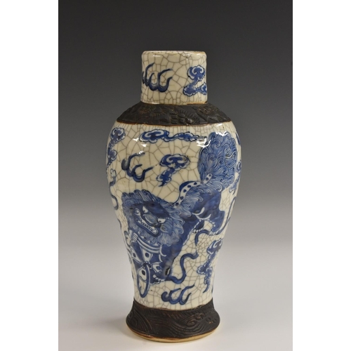 411 - A 19th century Chinese crackle glaze baluster vase, decorated in cobalt blue with dragons and clouds... 