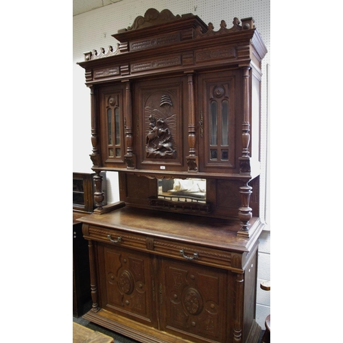 300 - A Flemish oak cupboard, shaped pediment, central cupboard carved with hunting scene flanked by astra... 