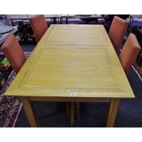 354 - A contemporary light oak extending dining table and four upholstered chairs. (5)