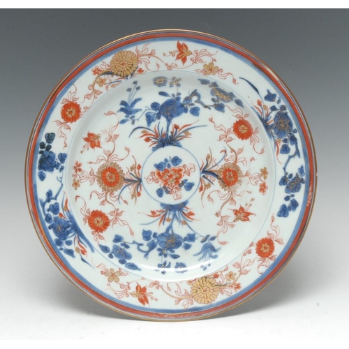 483 - An 18th century Chinese circular plate, decorated in the Imari palette with flowers and stylised fol... 