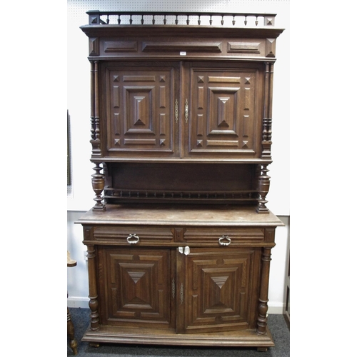 374 - A Flemish oak cupboard, spindled gallery, block fronted cupboard doors over recess, two short drawer... 