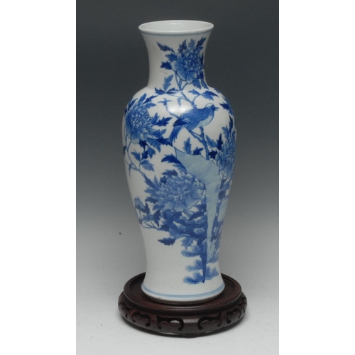 495 - A Chinese baluster vase, pencilled and painted in tones of underglaze blue with a songbird among chr... 