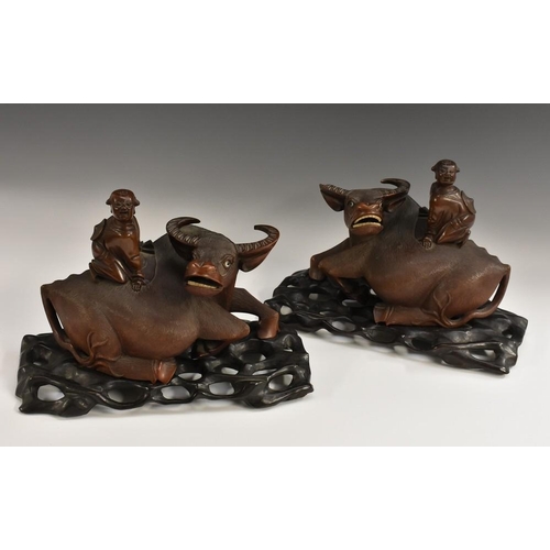 506 - A pair of Chinese hardwood models, The Boy on the Buffalo, the child on the back of the buffaloes, h... 