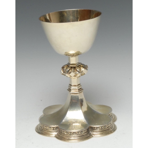 570 - A 20th century silver gilt chalice, of typical form, gilded bowl, the column with angular knop, peta... 