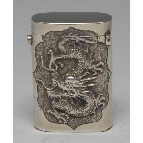 573 - A Chinese silver rounded rectangular vesta case, chased with a ferocious dragon, to verso with chrys... 