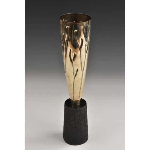 577 - A contemporary sterling silver trophy, of elongated form, embossed with stylised fronds, granite bas... 