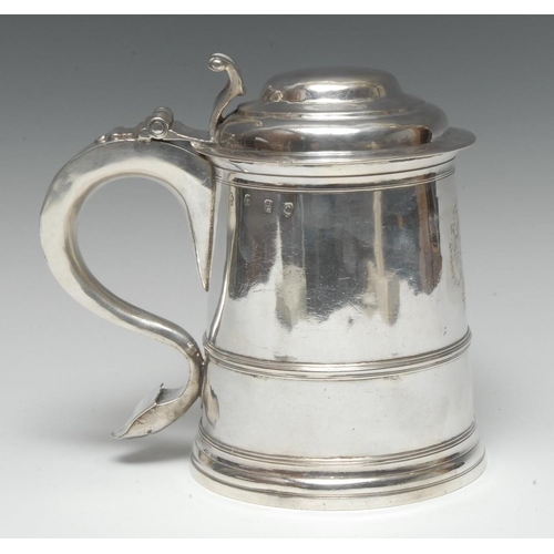 586 - A George I silver spreading cylindrical tankard, hinged domed cover with scroll thumb-piece, S-scrol... 