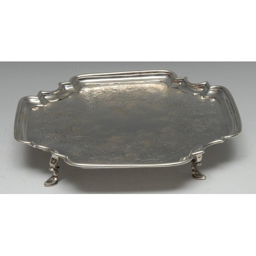 588 - A George II Provincial silver shaped incurved square salver, the field flat chased with a band of fl... 