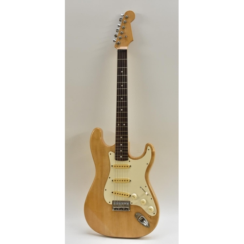 3127 - A Stratocaster type electric guitar, natural finish body with white pickguard, complete with case.