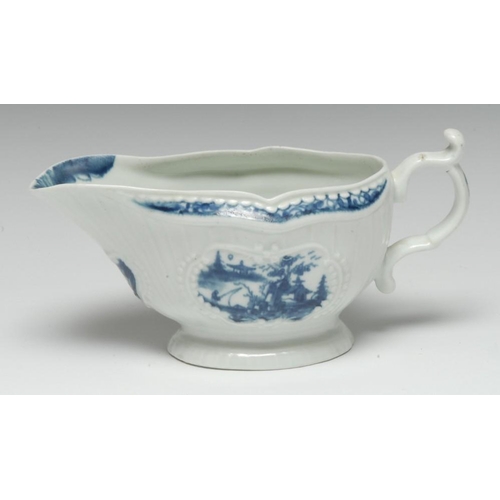 72 - A  Worcester Fisherman and Billboard Island pattern strap fluted sauce boat, painted in blue with tw... 