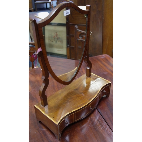 149 - A Regency mahogany shield shaped dressing mirror, one long and two short drawers to serpentine base.