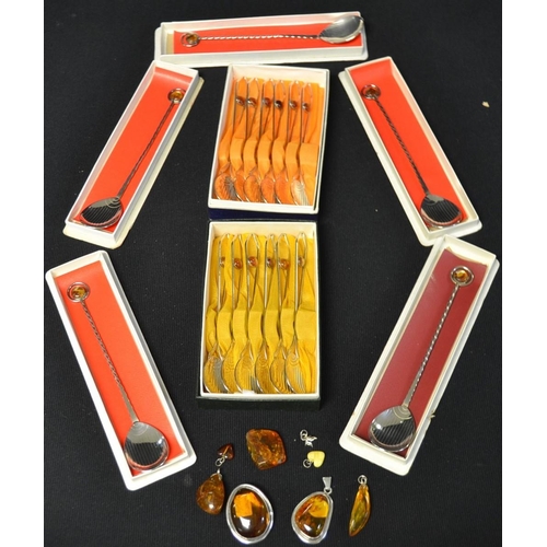 5297 - A quantity of hand planished white metal spoons, amber inset; a silver and amber brooch; other amber