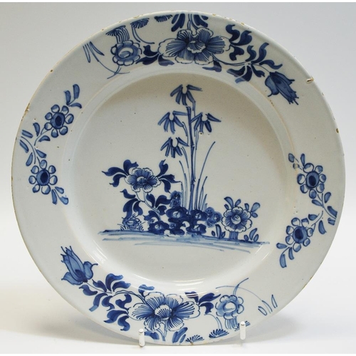 20 - A Delft circular plate, painted in underglaze blue with bamboo and peonies, 23cm diam, c.1760