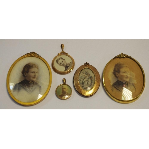 216 - A 9ct gold circular double sided photograph locket; another smaller;  a gilt metal locket portrait m... 