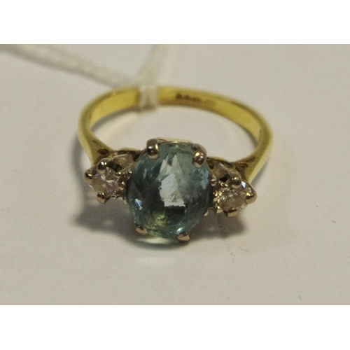 240 - An 18ct gold ring set with a central oval tourmaline and two brilliant cut diamonds to one side, tot... 