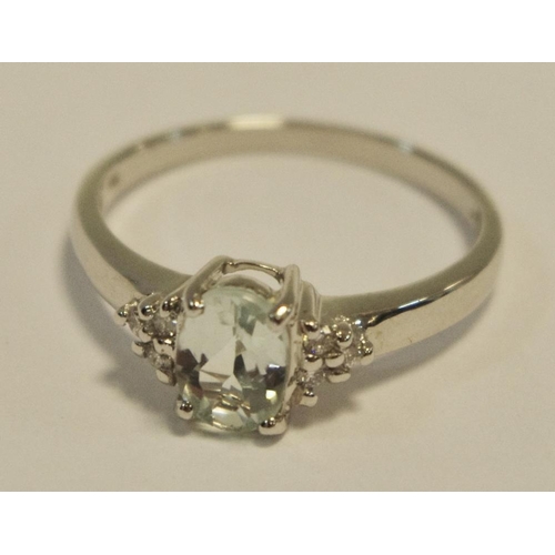 244 - An 18ct white gold ring set with an oval tourmaline approx 0.56cts and six brilliant cut diamonds to... 