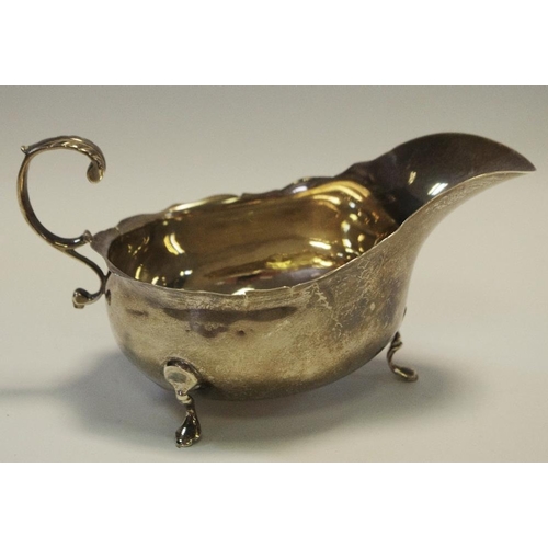 253 - A George IV silver sauce boat, marks rubbed, foliate scrolled handle c.1825 99g gross