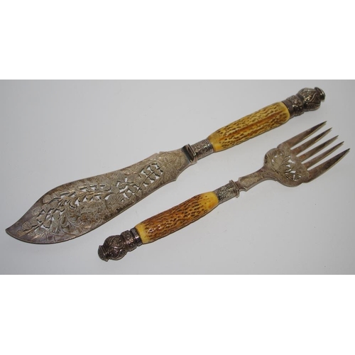 265 - A pair of Victorian silver horn hafted fish servers, with foliage, horn hafts, Sheffield 1887