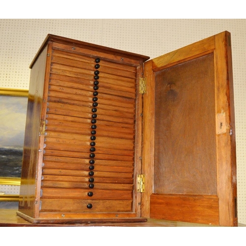 308 - A twenty five section coin collectors cabinet.