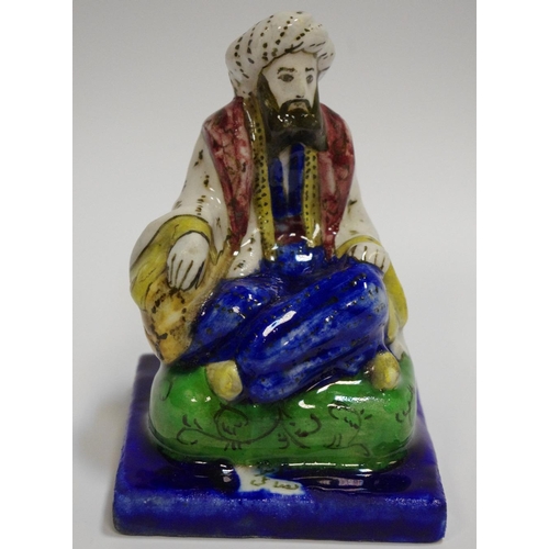 38 - A 19th century glazed figure, of a seated Turk