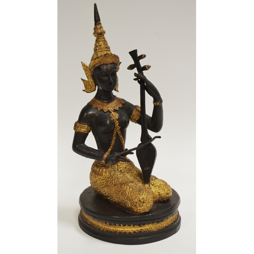 53 - An Indian deity of a traditional musician, seated, plinth base, picked out in gilt