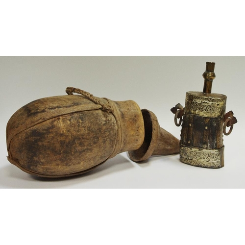 54 - A tribal gourd water vessel and cover; a late 19th/early 20th century Indian powder flask, white met... 