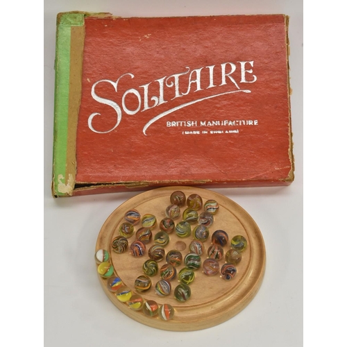 3123 - Games - a British thirty two glass marble and wooden solitaire set, circular light wooden base board... 