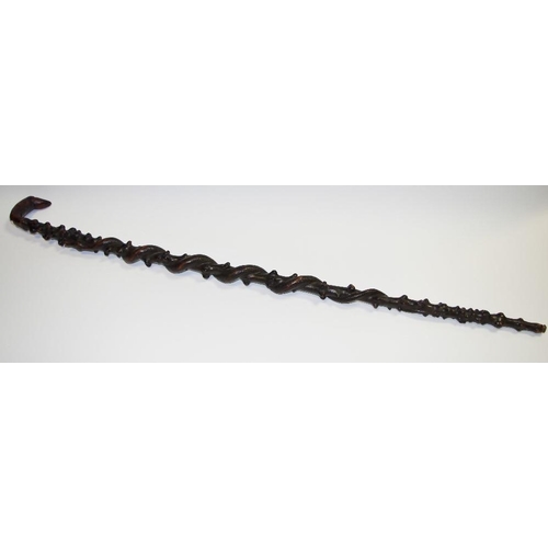 90 - An Anglo Indian walking stick, the handle with dog's head terminal,knobbled shaft, entwined with ser... 